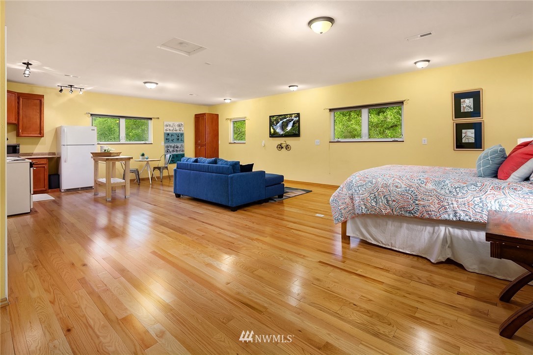 27819 Southeast Issaquah-Fall City Road Fall City, WA 98024 - Photo 33 of 39 a bedroom with furniture and a wooden floor
