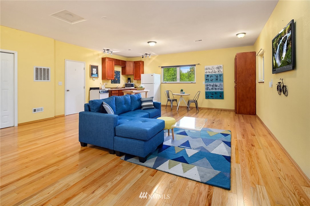 27819 Southeast Issaquah-Fall City Road Fall City, WA 98024 - Photo 34 of 39 a living room with furniture and a wooden floor
