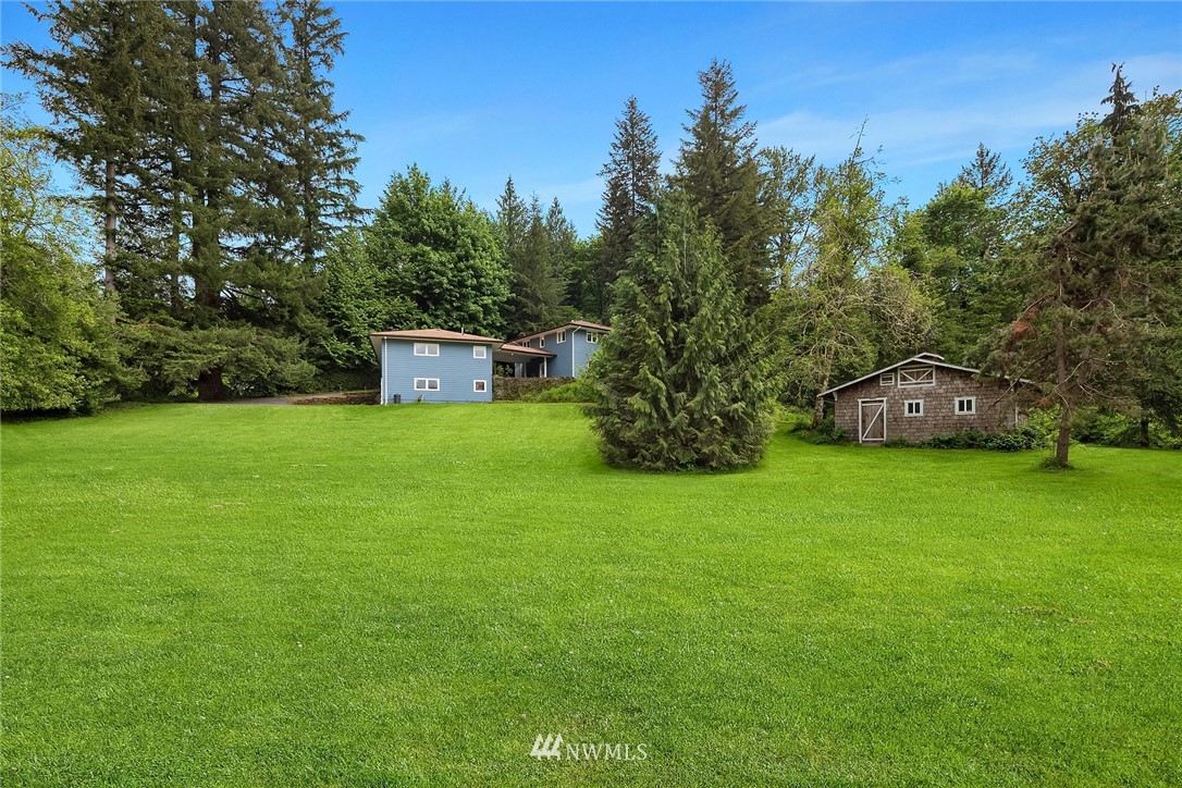 27819 Southeast Issaquah-Fall City Road Fall City, WA 98024 - Photo 38 of 39 a view of a white house with a yard and sitting area