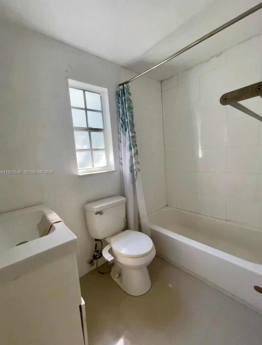 531 Northeast 68th Street, Unit 1 Miami, FL 33138 - Photo 8 of 11 a bathroom with a toilet sink and shower