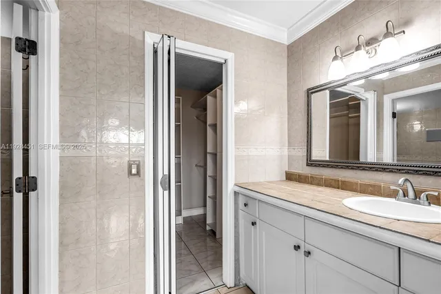 a bathroom with a granite countertop sink mirror and shower