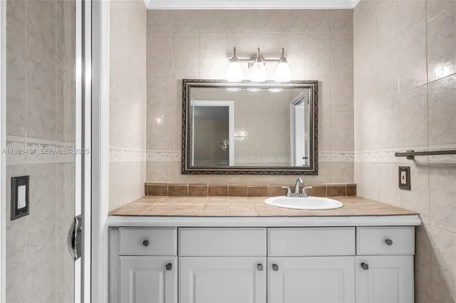 a bathroom with double sink and a mirror