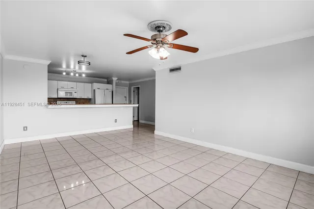 a view of a kitchen with microwave and cabinets