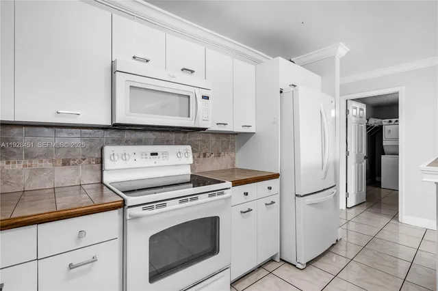 a kitchen with cabinets and appliances