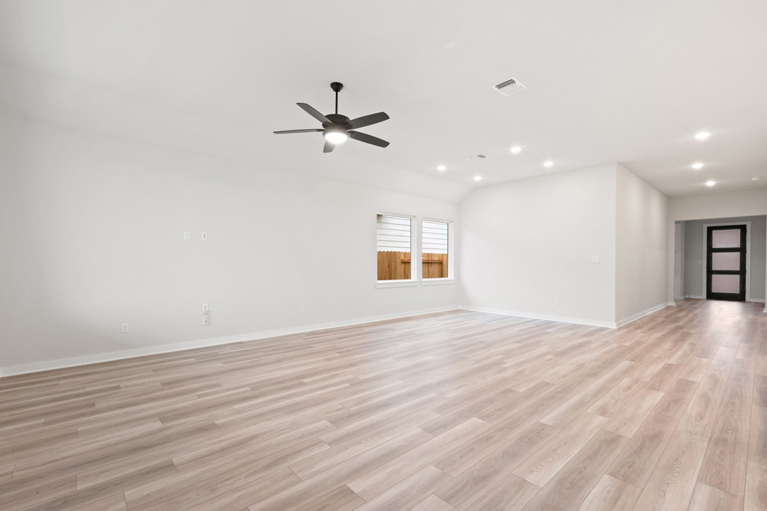 16201 Smithers Road Manor, TX 78653 - Photo 8 of 40 a view of empty room with wooden floor and ceiling fan