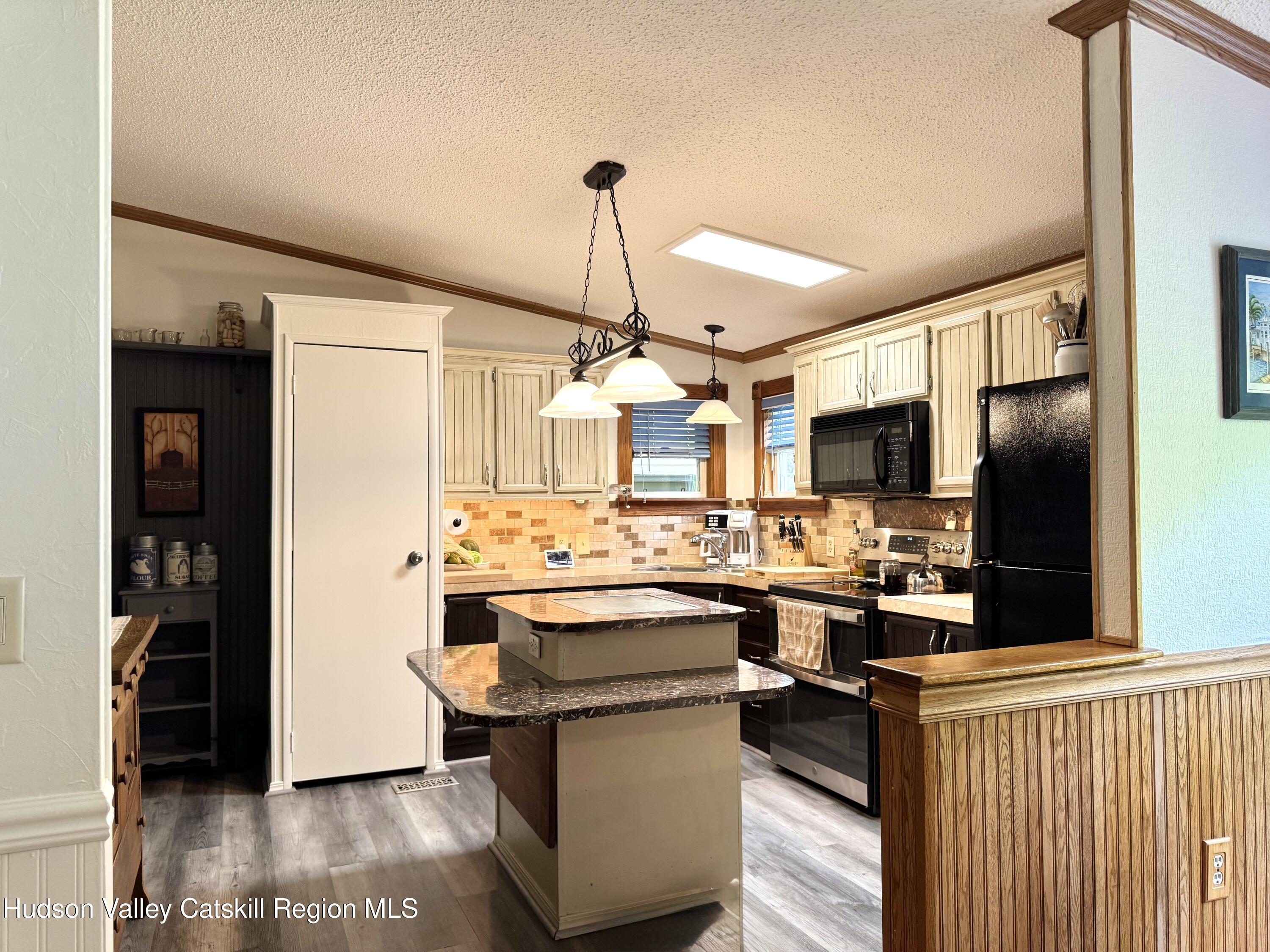 382 Cairo Junction Road Catskill, NY 12414 - Photo 11 of 26 a kitchen with a sink and refrigerator