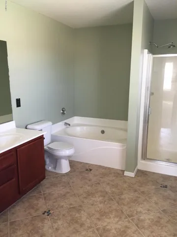 a bathroom with a bathtub and toilet