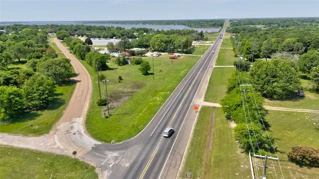 an aerial view of a residential houses with outdoor space and swimming pool