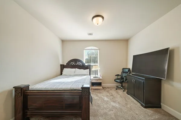 a bedroom with a bed and a flat screen tv