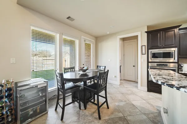 a view of a dining room with furniture and window
