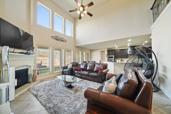 a living room with furniture a flat screen tv and a fireplace