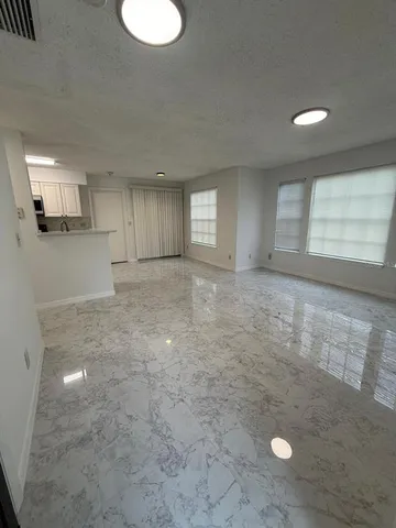 an empty room with a empty space and windows