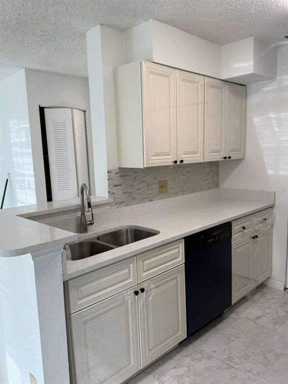 1089 South Hiawassee Road, Unit 314 Orlando, FL 32835 - Photo 15 of 24 a kitchen with granite countertop white cabinets and white appliances