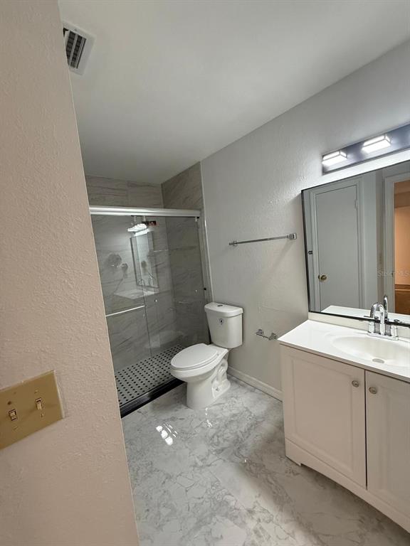 1089 South Hiawassee Road, Unit 314 Orlando, FL 32835 - Photo 17 of 24 a bathroom with a granite countertop sink toilet and shower