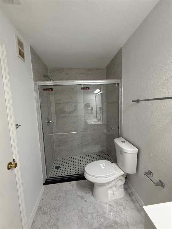1089 South Hiawassee Road, Unit 314 Orlando, FL 32835 - Photo 18 of 24 a bathroom with a toilet and a shower
