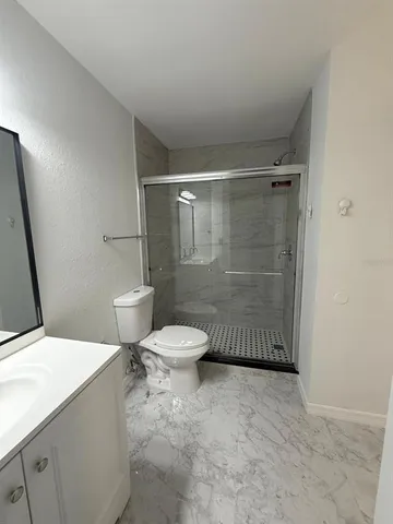 a white toilet sitting next to a bathroom sink