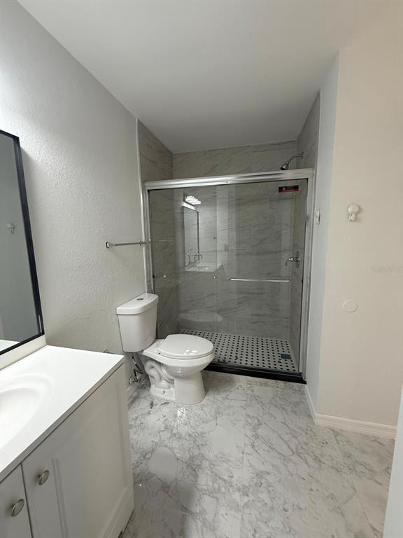 1089 South Hiawassee Road, Unit 314 Orlando, FL 32835 - Photo 20 of 24 a white toilet sitting next to a bathroom sink