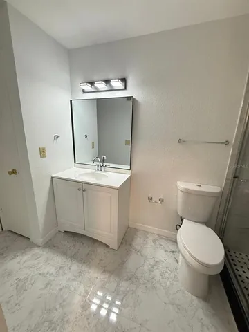 a white toilet sitting next to a bathroom sink