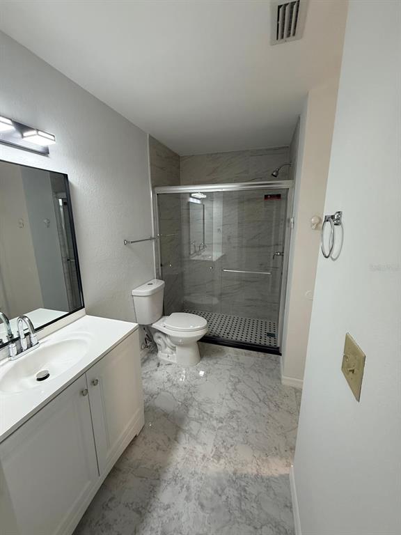 1089 South Hiawassee Road, Unit 314 Orlando, FL 32835 - Photo 22 of 24 a bathroom with a sink a toilet and shower