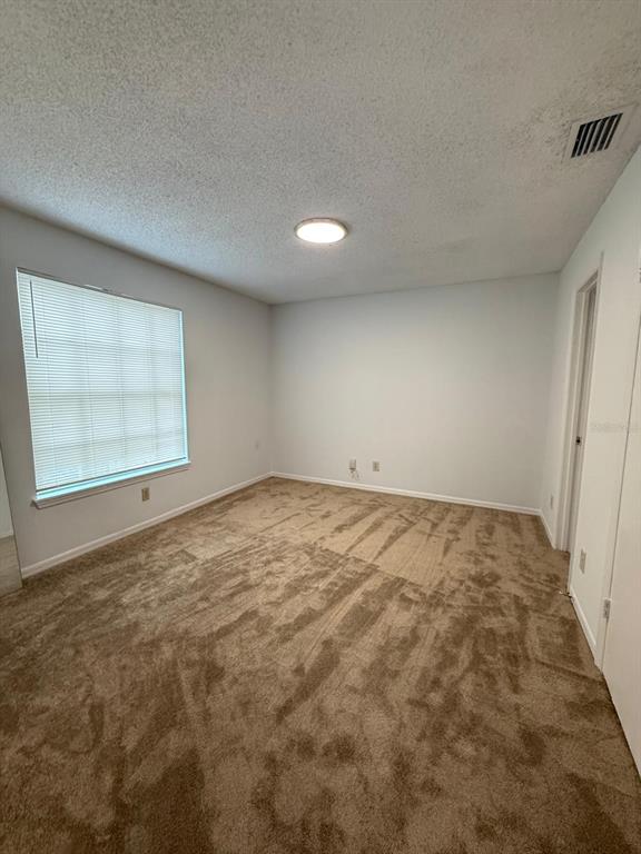1089 South Hiawassee Road, Unit 314 Orlando, FL 32835 - Photo 23 of 24 an empty room with a empty space and windows