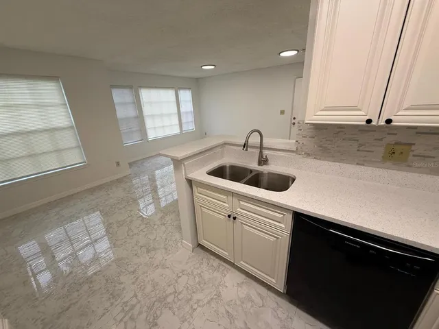 a kitchen with a sink and cabinets