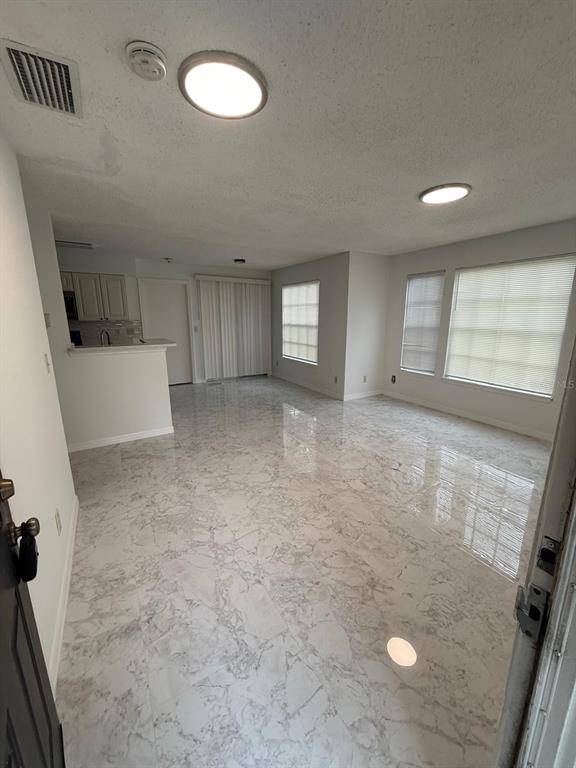 1089 South Hiawassee Road, Unit 314 Orlando, FL 32835 - Photo 6 of 24 wooden floor in an empty room with a window