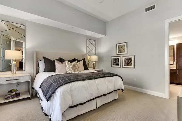 a bedroom with a bed and wall painting