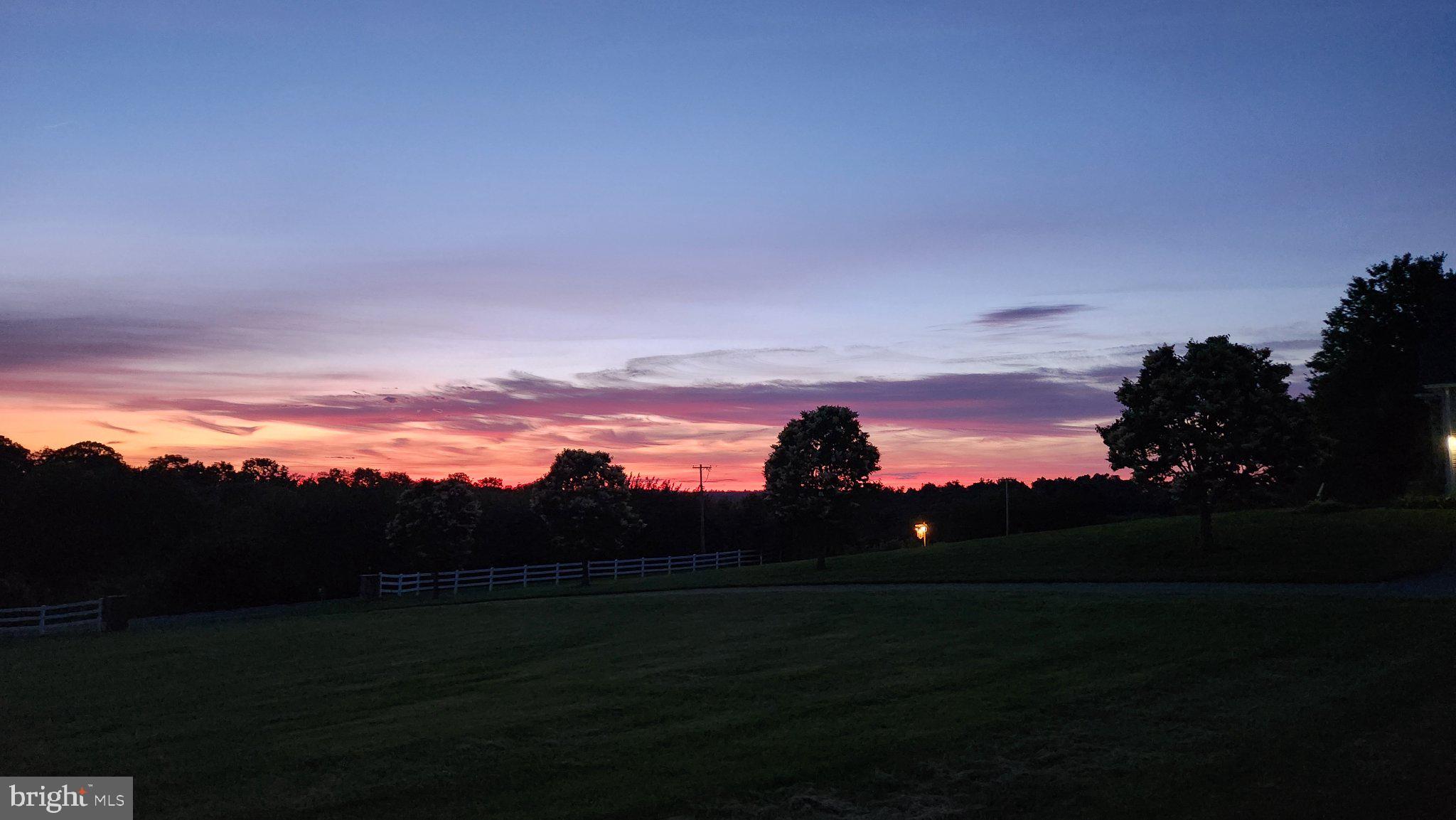 9855 McKinstry Mill Road New Windsor, MD 21776 - Photo 72 of 76 Serene twilight over lush fields.