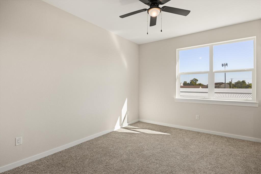 529 Galt Drive Stephenville, TX 76401 - Photo 16 of 27 an empty room with windows and ceiling fan