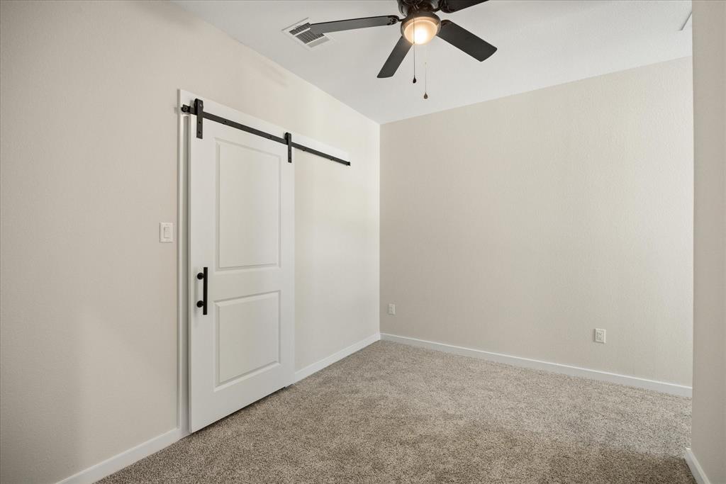 529 Galt Drive Stephenville, TX 76401 - Photo 21 of 27 an empty room with a window and a fan