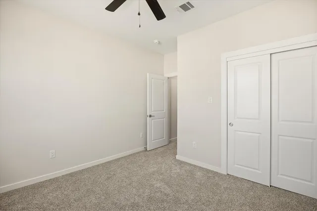 an empty room with ceiling fan