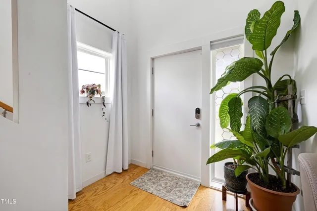a living room with furniture a chandelier and a potted plant