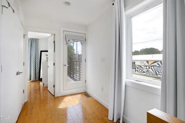 a wooden deck with a white fence and wooden floor