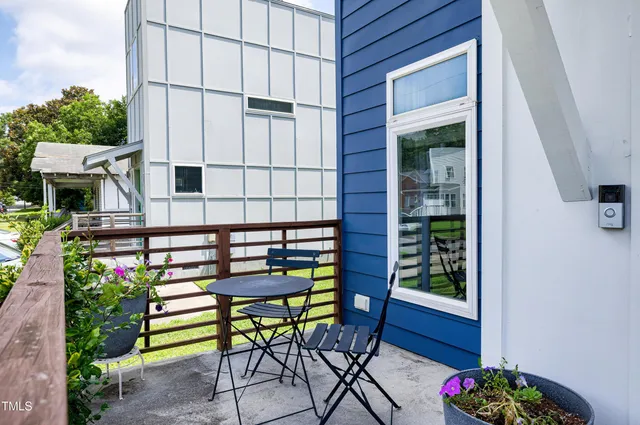 a view of a chair and table in backyard of the house