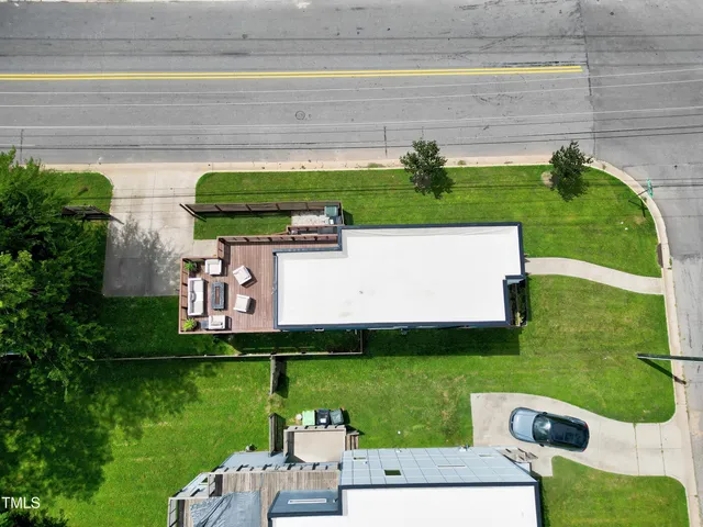 an aerial view of a house with a yard