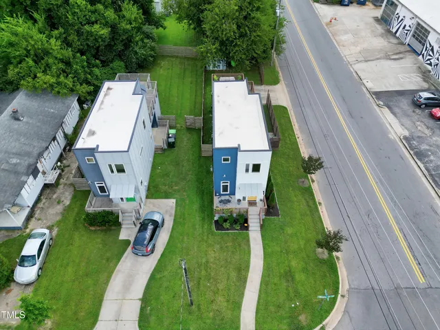 a view of a house with a yard and a garden