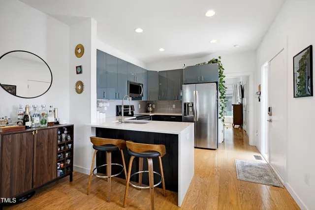 a kitchen with stainless steel appliances a refrigerator and a stove top oven