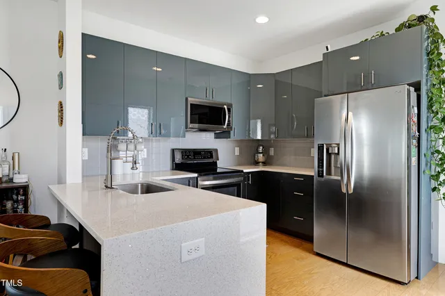 a kitchen with a sink stove and microwave