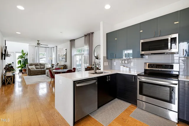 a living room with furniture a chandelier and a window
