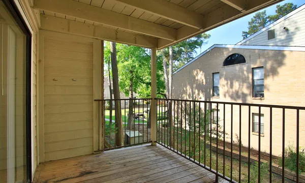 a view of balcony with wooden floor
