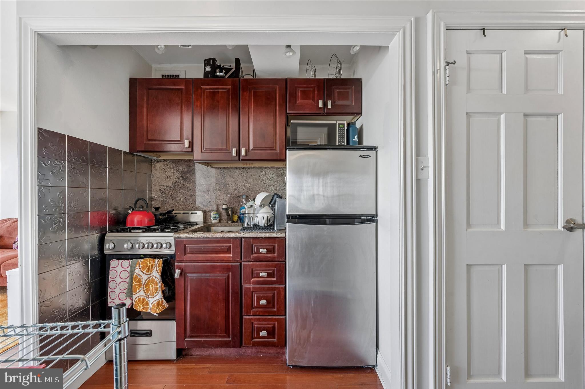 1810 Rittenhouse Square, Unit 2007 Philadelphia, PA 19103 - Photo 13 of 25 a kitchen with stainless steel appliances granite countertop a refrigerator and a stove