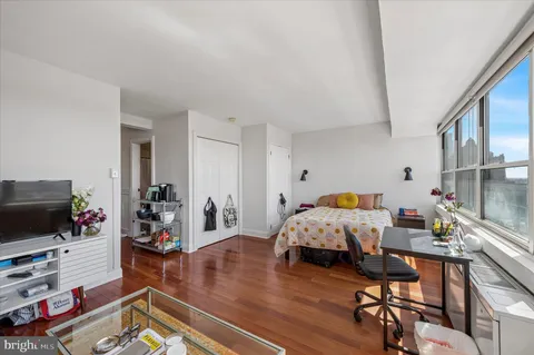 a bed room with furniture and a flat screen tv