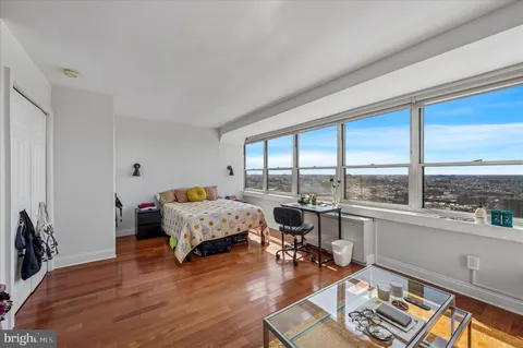 a living room with furniture and floor to ceiling window