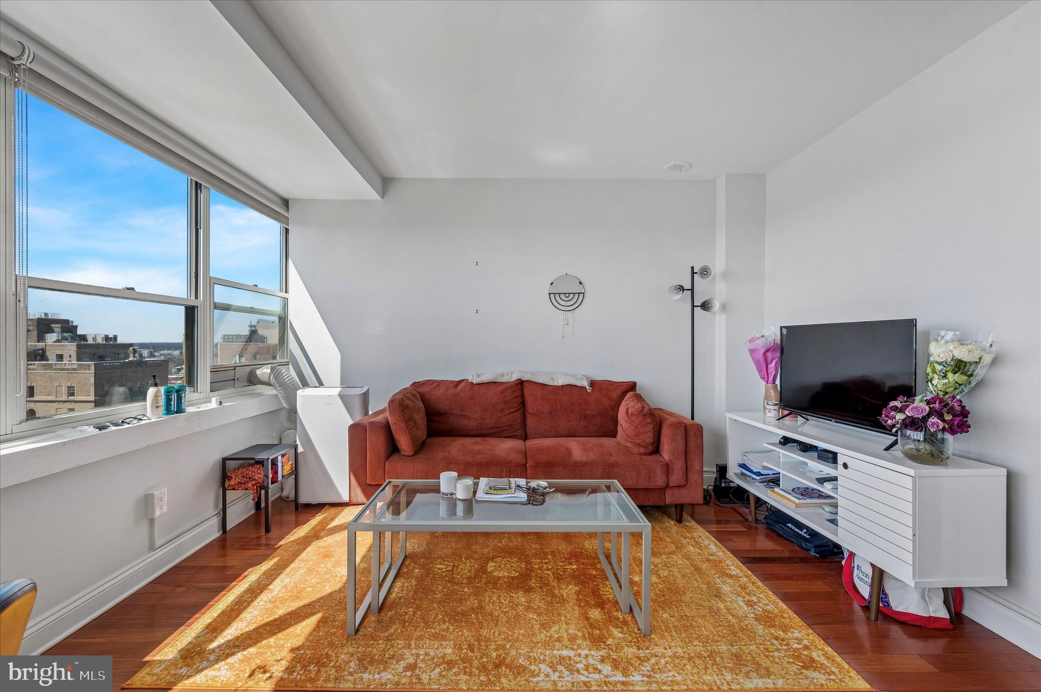 1810 Rittenhouse Square, Unit 2007 Philadelphia, PA 19103 - Photo 17 of 25 a living room with furniture and a flat screen tv