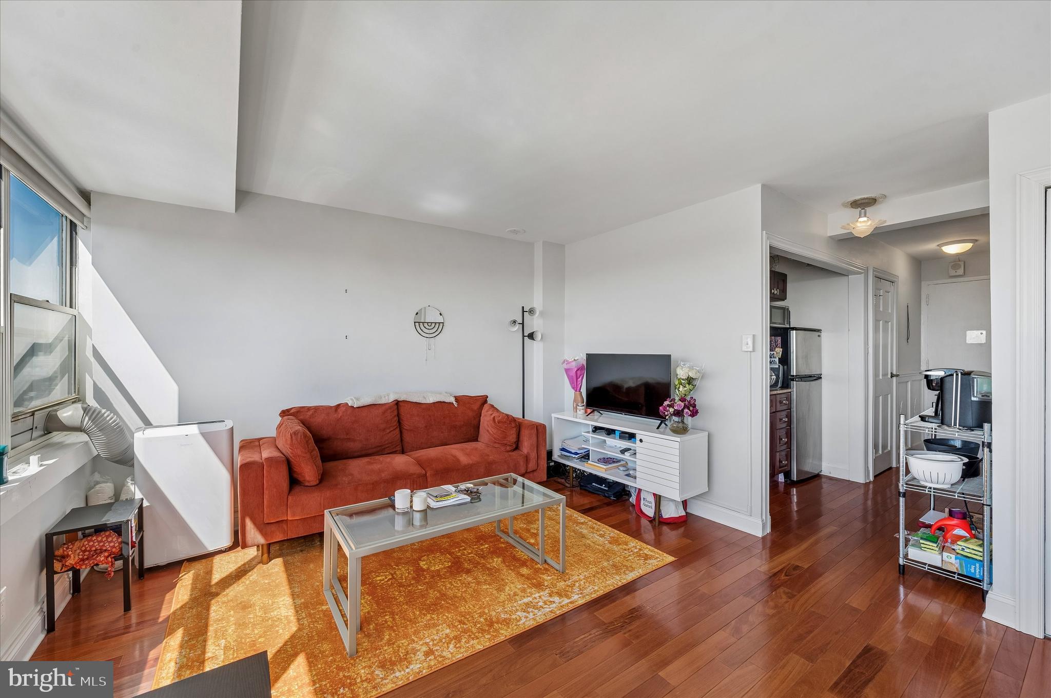 1810 Rittenhouse Square, Unit 2007 Philadelphia, PA 19103 - Photo 19 of 25 a living room with furniture a flat screen tv and a wooden floor
