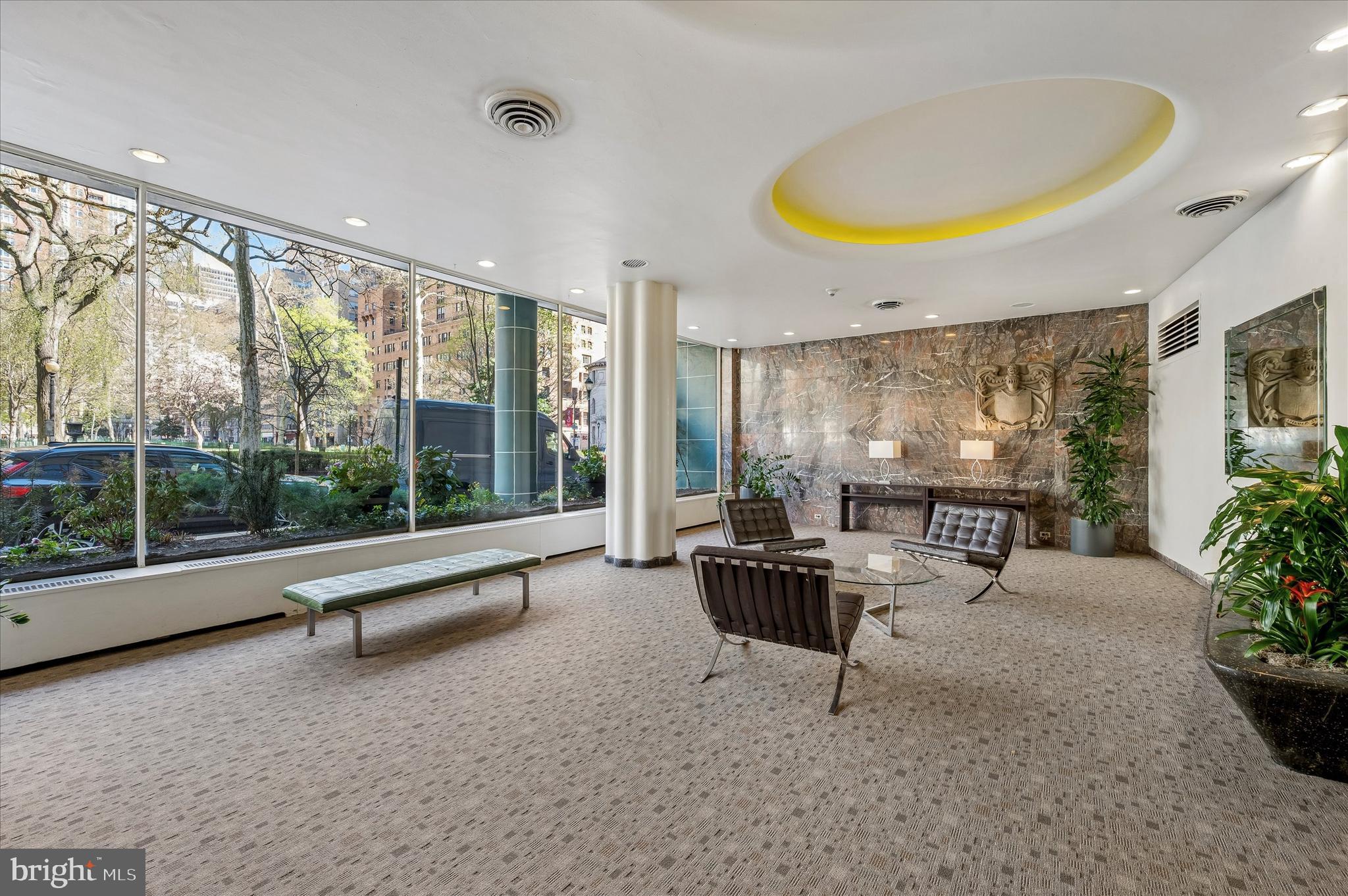 1810 Rittenhouse Square, Unit 2007 Philadelphia, PA 19103 - Photo 3 of 25 a living room with furniture and a large window