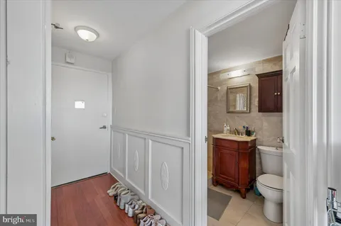 a bathroom with a toilet a sink a vanity and mirror