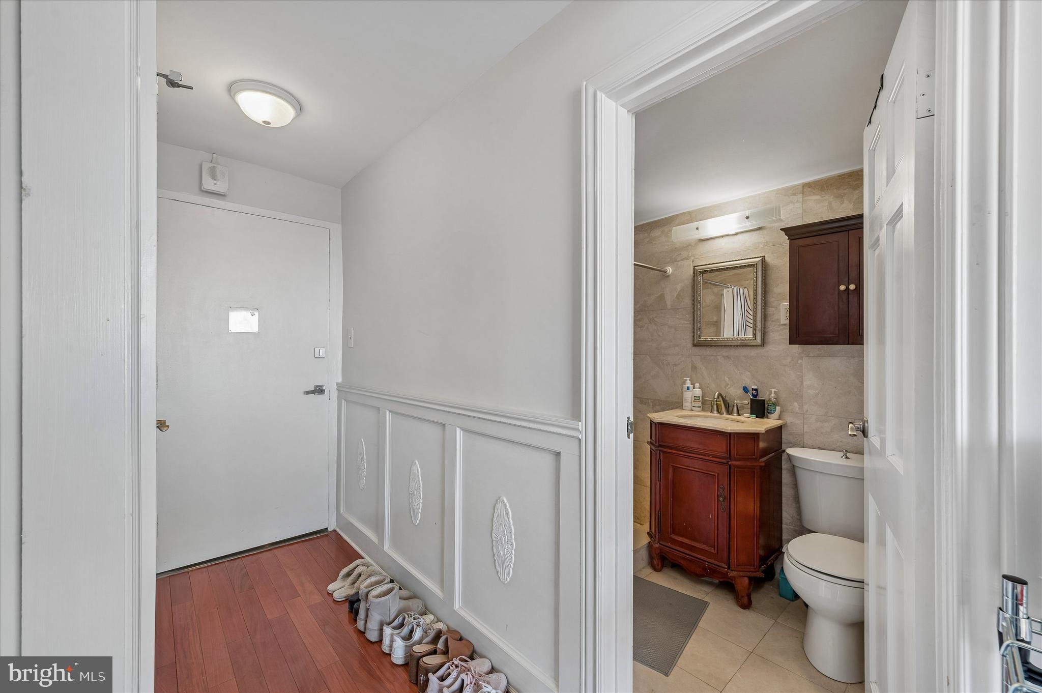 1810 Rittenhouse Square, Unit 2007 Philadelphia, PA 19103 - Photo 8 of 25 a bathroom with a toilet a sink a vanity and mirror