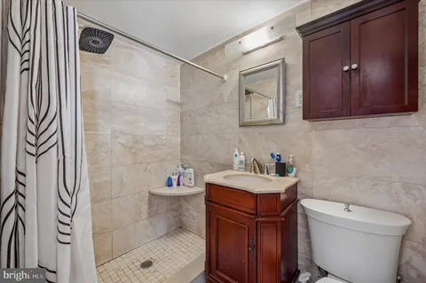 a bathroom with a toilet sink and mirror