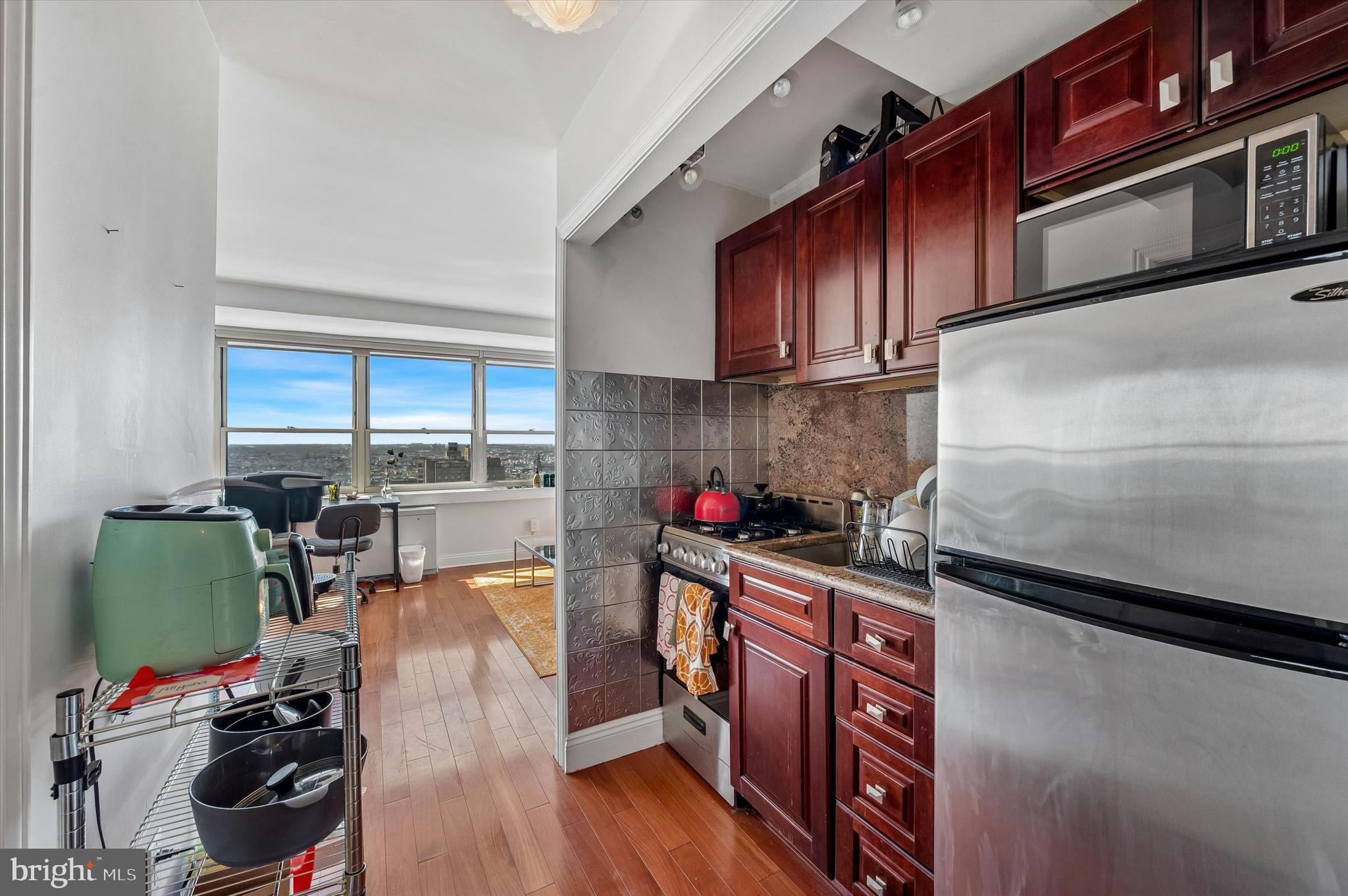 1810 Rittenhouse Square, Unit 2007 Philadelphia, PA 19103 - Photo 10 of 25 a kitchen with stainless steel appliances granite countertop a refrigerator sink and cabinets